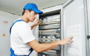 Licensed electrician inspecting an electrical panel to diagnose flickering lights